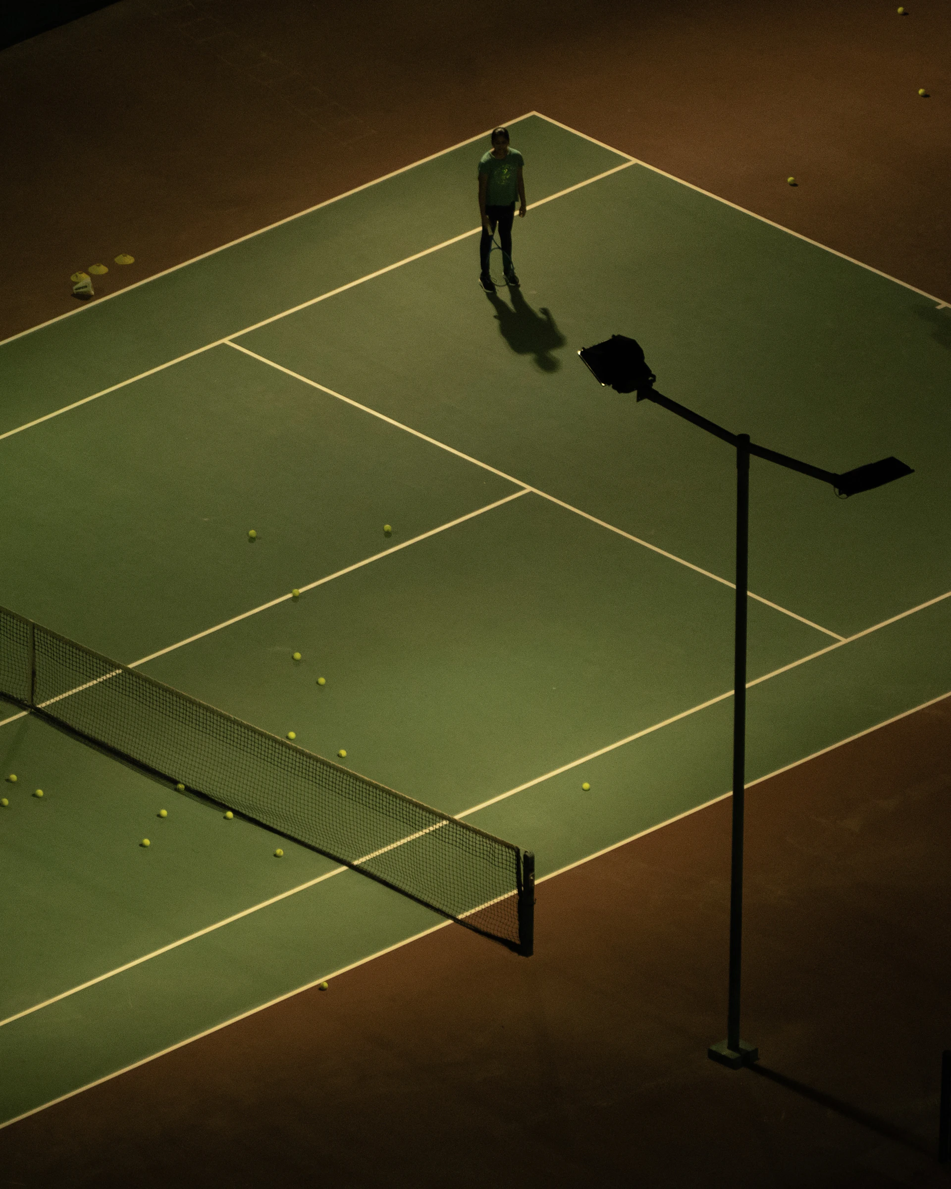 a man standing on a tennis court holding a racquet