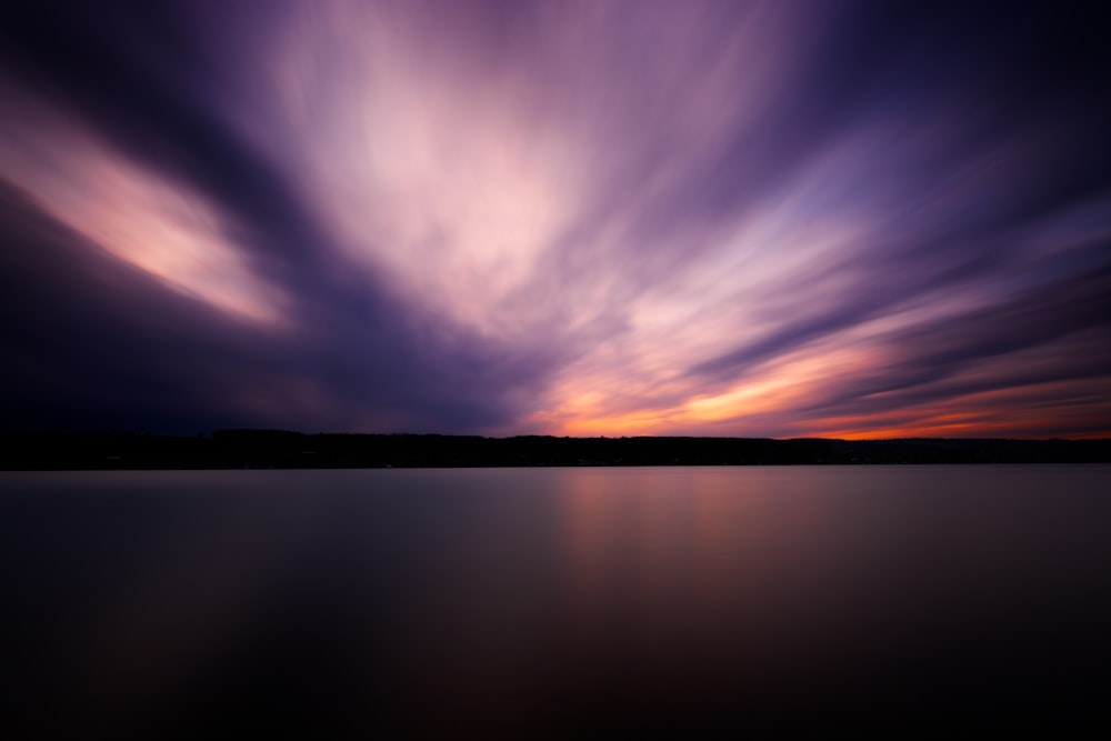 a long exposure of a sunset over a body of water