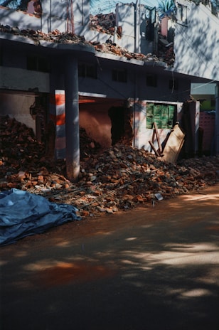 a pile of rubble sitting in front of a building