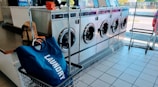 a laundry machine with a laundry bag in front of it