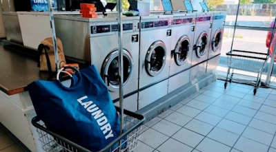 a laundry machine with a laundry bag in front of it