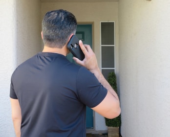a man holding a cell phone up to his ear
