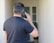 a man holding a cell phone up to his ear