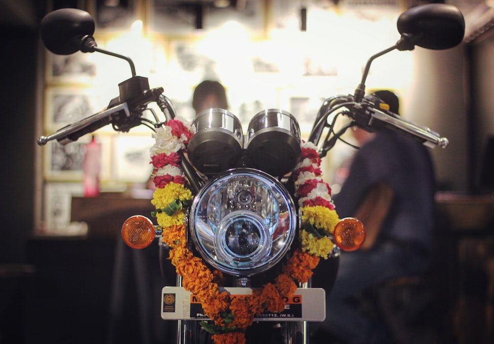 a close up of a motorcycle decorated with flowers