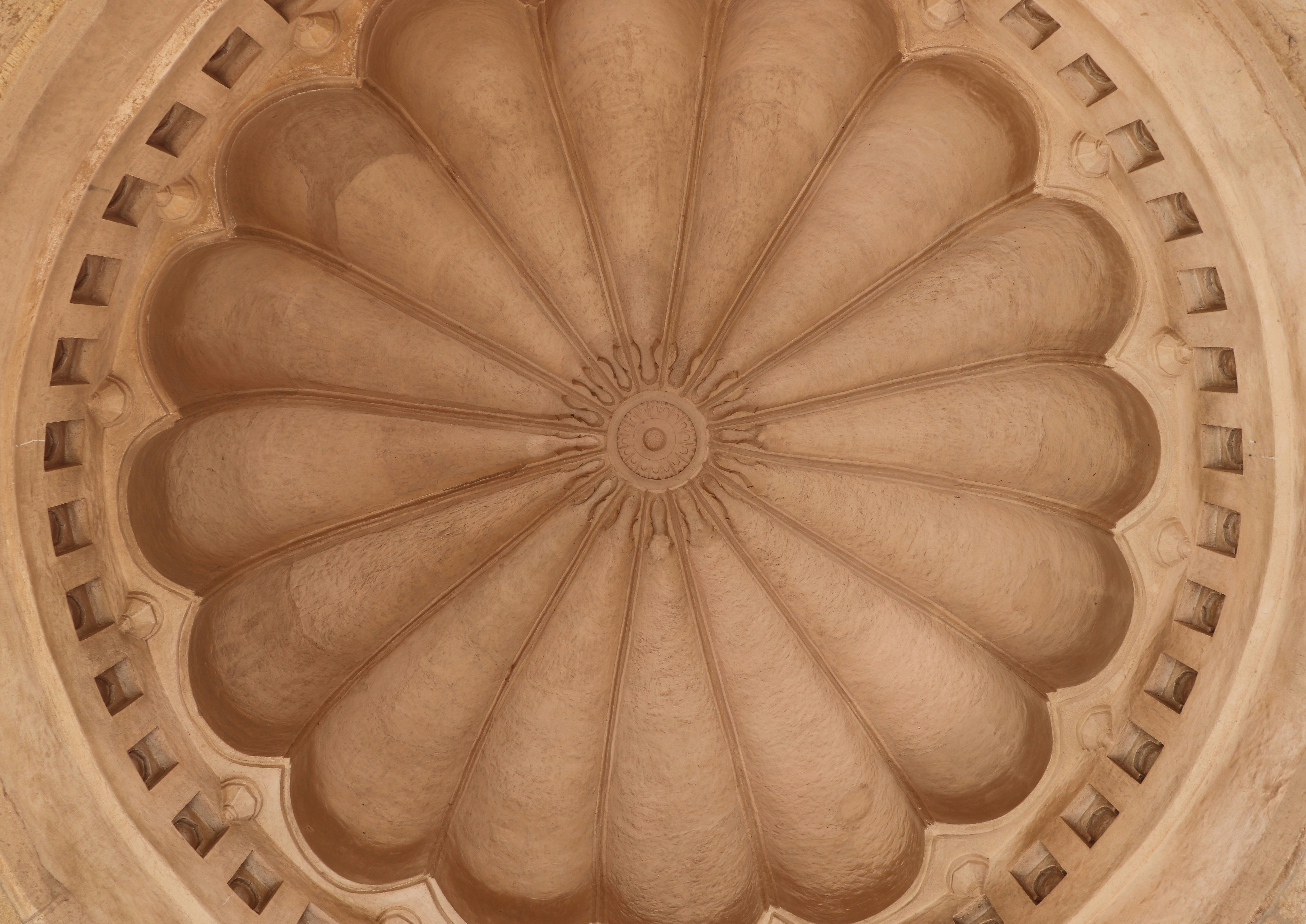 a decorative ceiling in a building with a circular design
