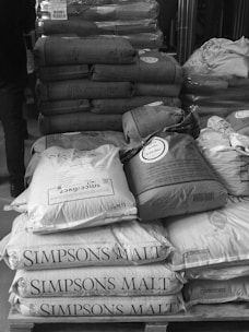 a pile of pillows sitting on top of a wooden table
