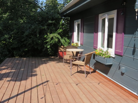 a patio with a table and chairs on it