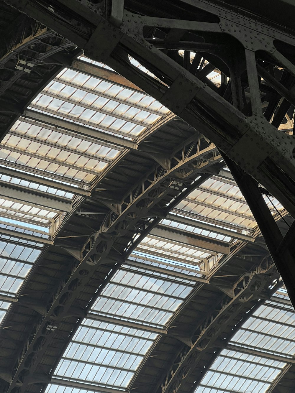 a large train station with many windows and a clock