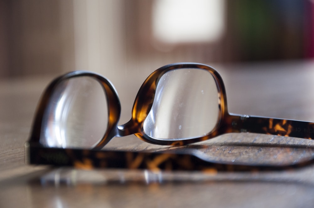 a pair of glasses sitting on top of a table