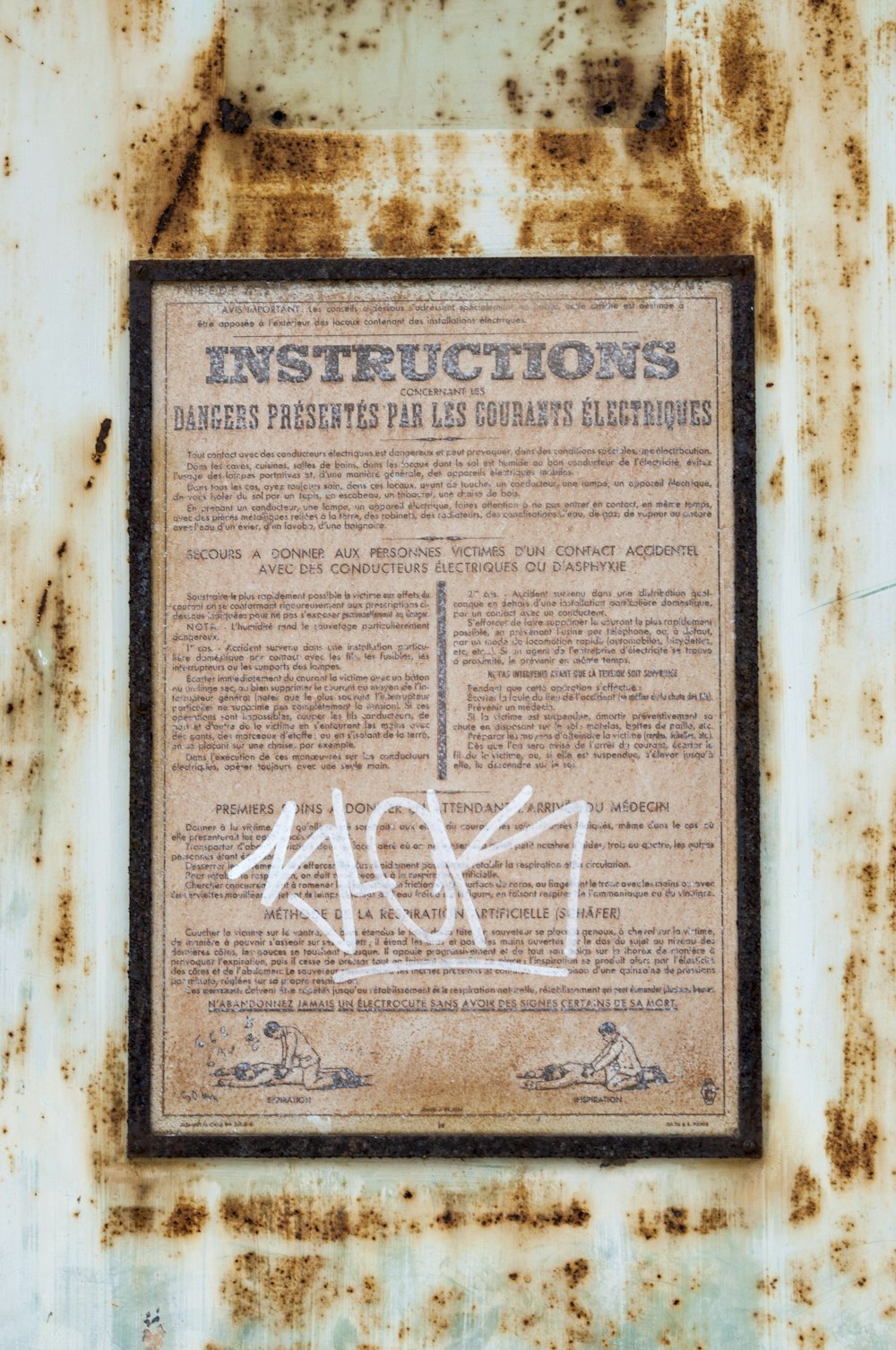 a rusted metal sign with writing on it