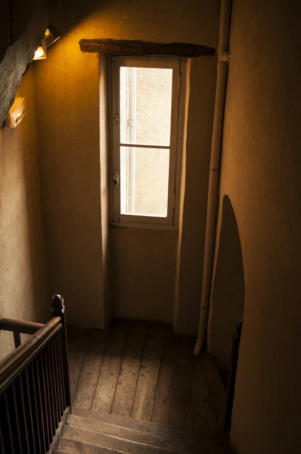 a staircase leading to a window in a house