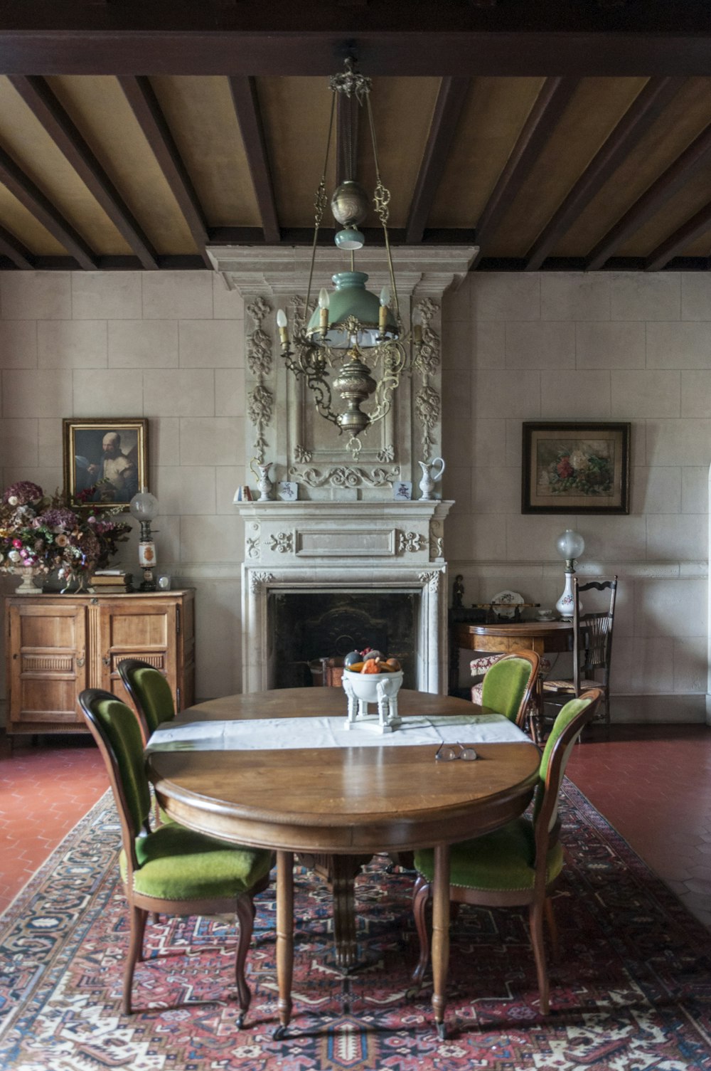 a dining room with a table, chairs and a fireplace