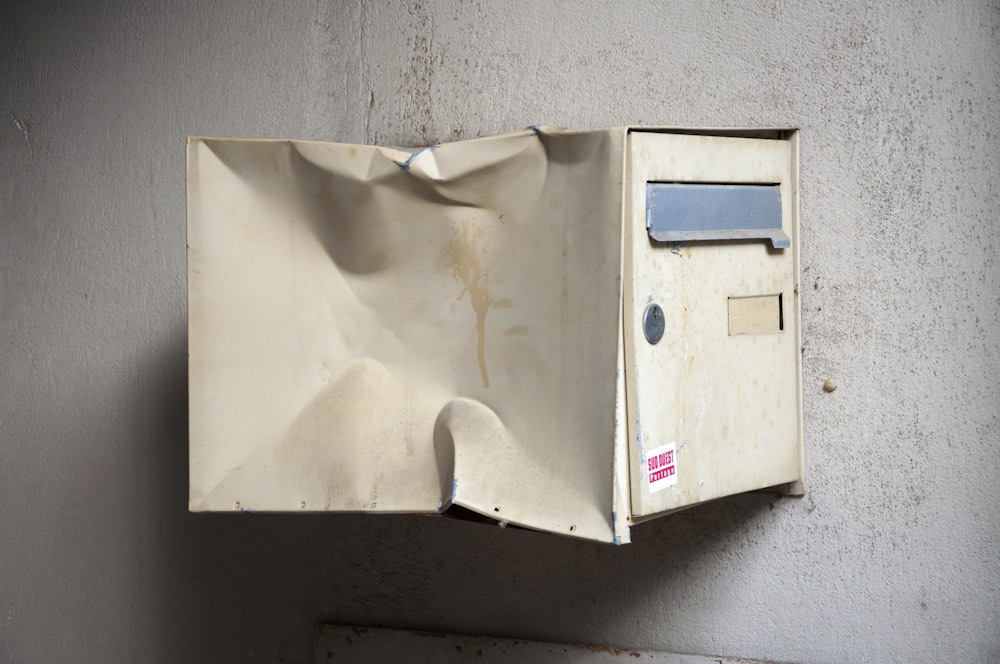 an old mailbox is hanging on a wall