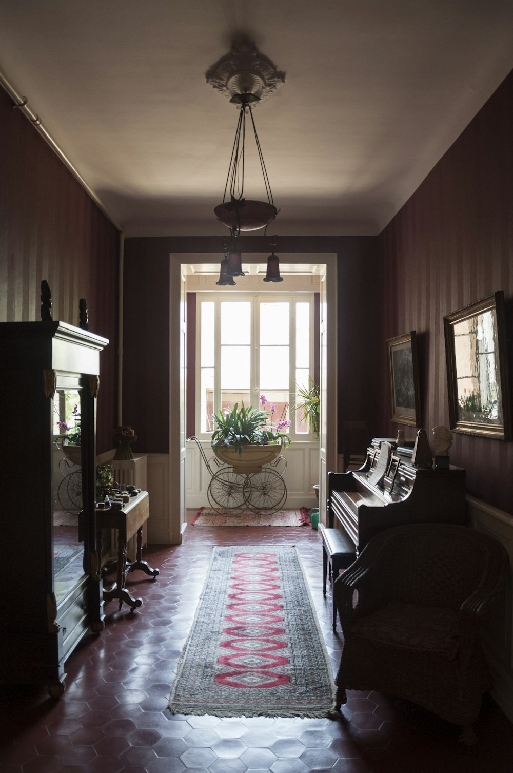 a living room with a piano and a rug