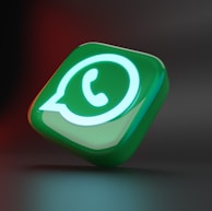 a green and white button with a phone on it