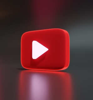 a red play button sitting on top of a table
