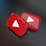 Two shiny, red, three-dimensional shapes resembling play buttons are positioned on a dark surface. Each button displays a white triangle in the center, which is characteristic of a popular video sharing platform.