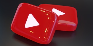 two red buttons with a white arrow on them