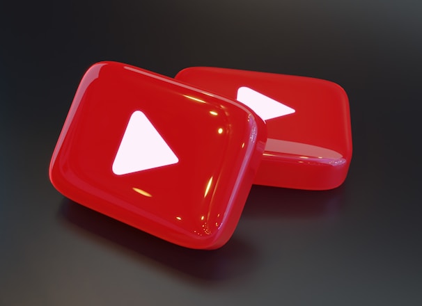 two red buttons with a white arrow on them