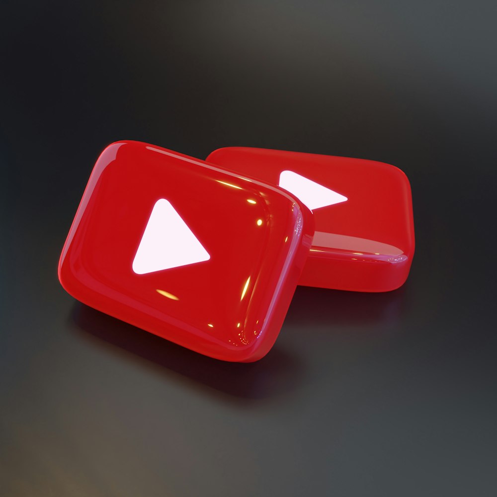 two red buttons with a white arrow on them