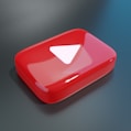 a red object with a white triangle on it