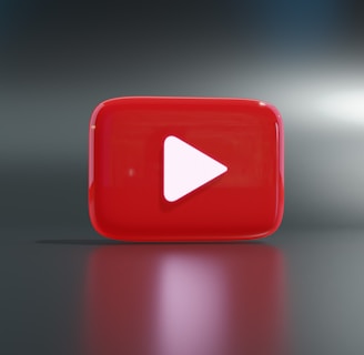 a red play button sitting on top of a table