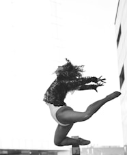 a woman is doing a trick on a skateboard