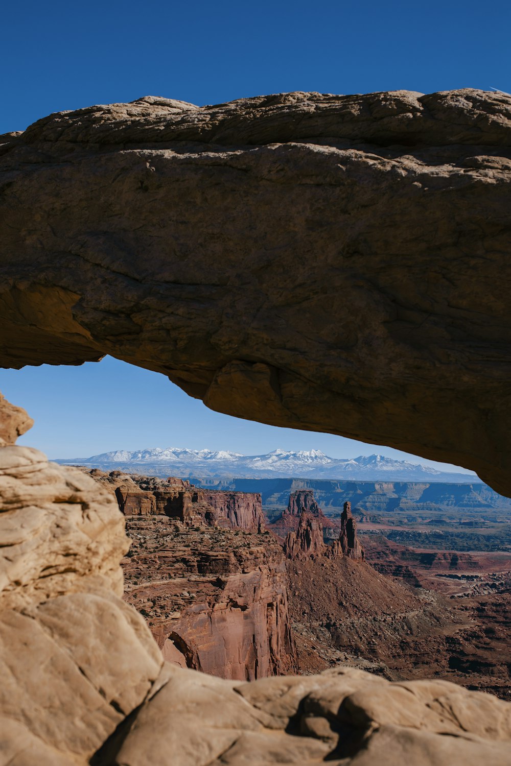 a large rock formation with a mountain in the background