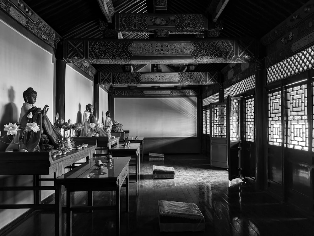 a black and white photo of a woman sitting in a room