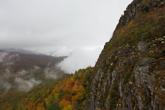 a view of a mountain with a foggy sky
