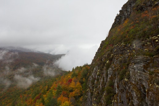 a view of a mountain with a foggy sky