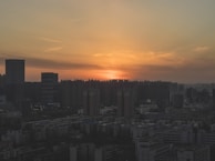 City skyline view at sunset with warm tones and clear sky.