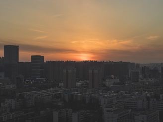 City skyline view at sunset with warm tones and clear sky.