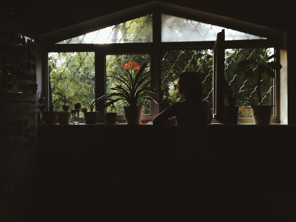 a person sitting at a counter in a dark room