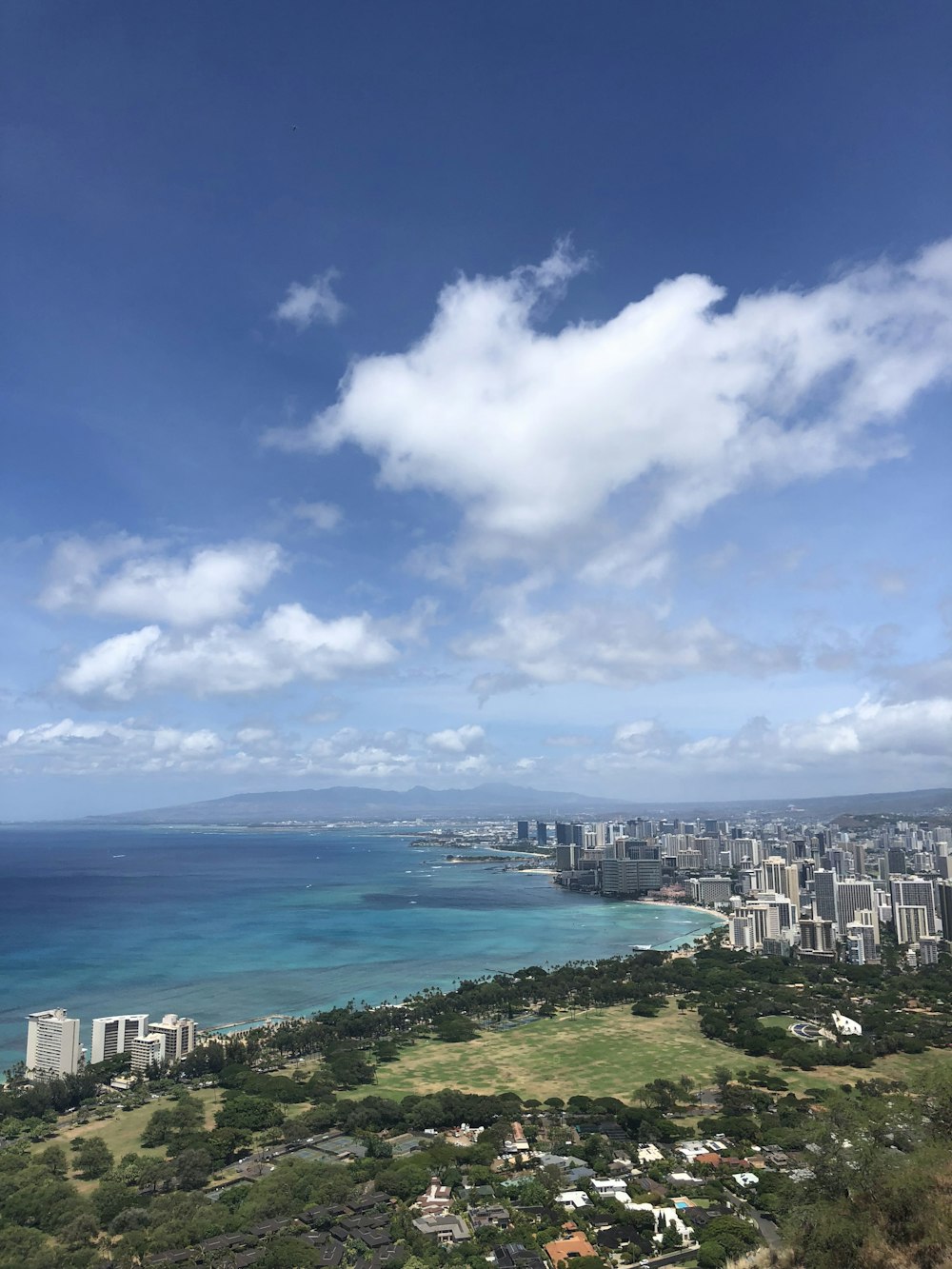 a scenic view of a city and the ocean