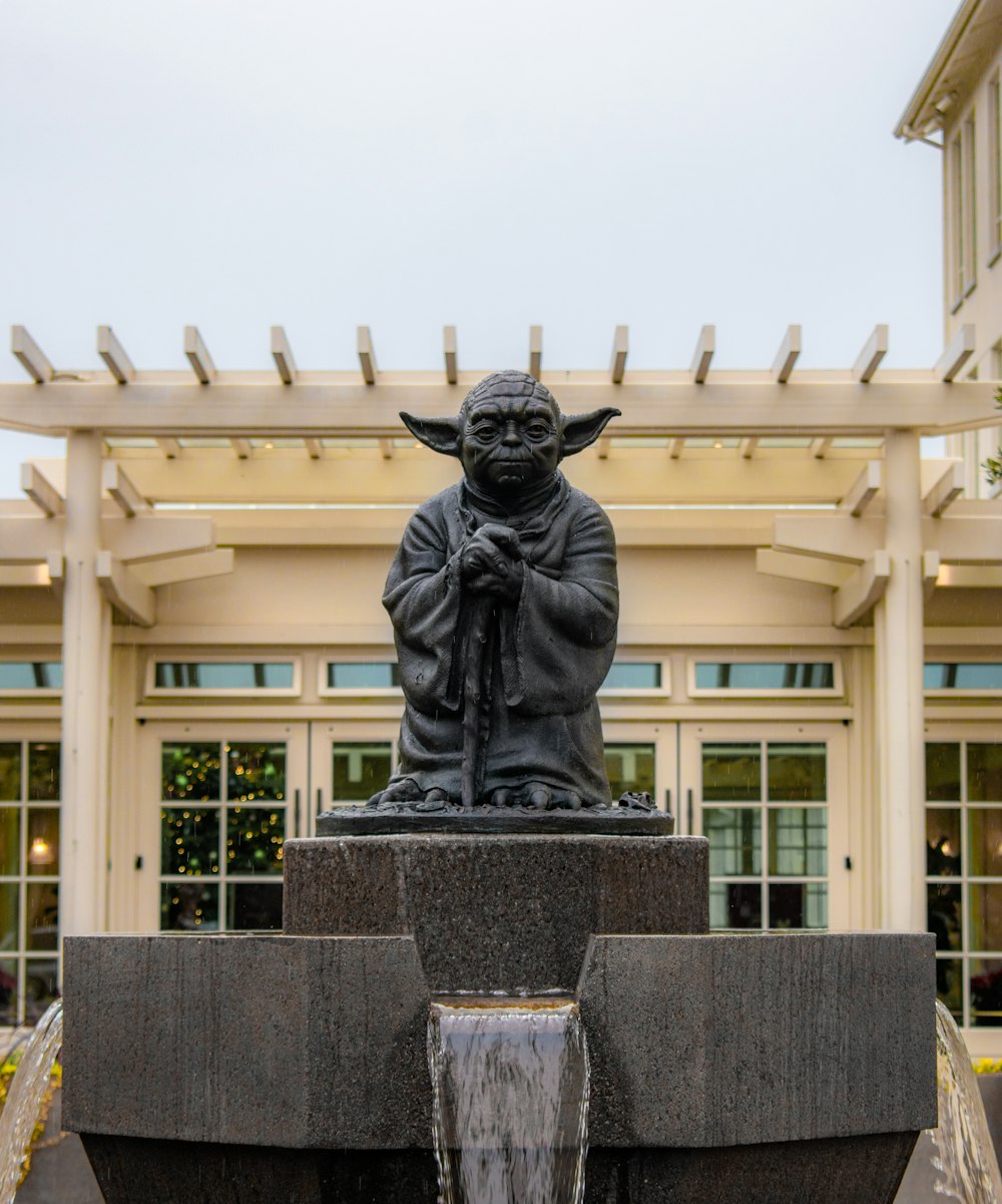 a statue of yoda in front of a building