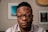 a man with glasses is looking at the camera