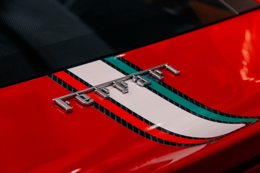 a close up of the hood of a red sports car