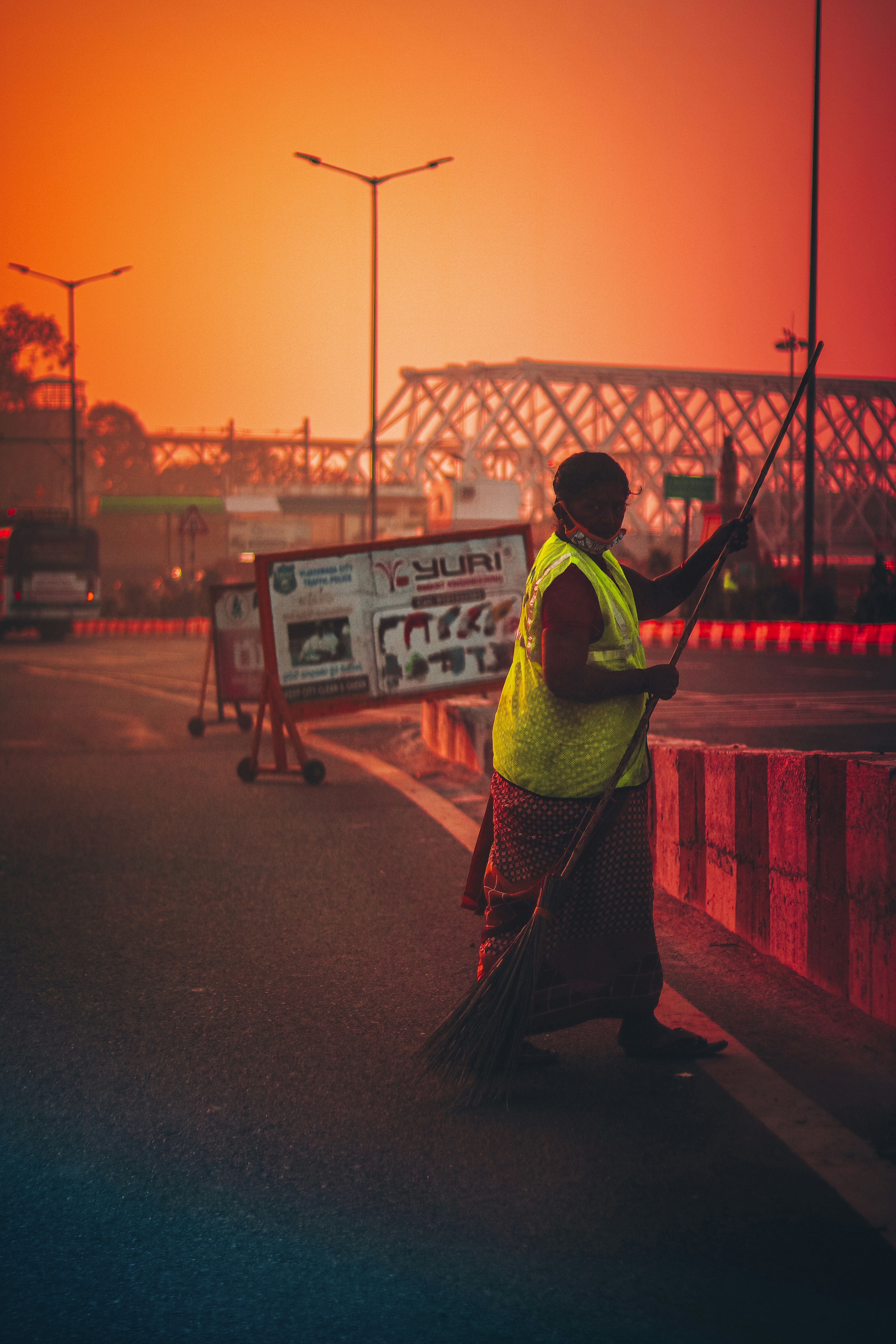 a woman sweeping the street with a broom