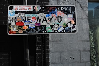 a street sign covered in lots of stickers