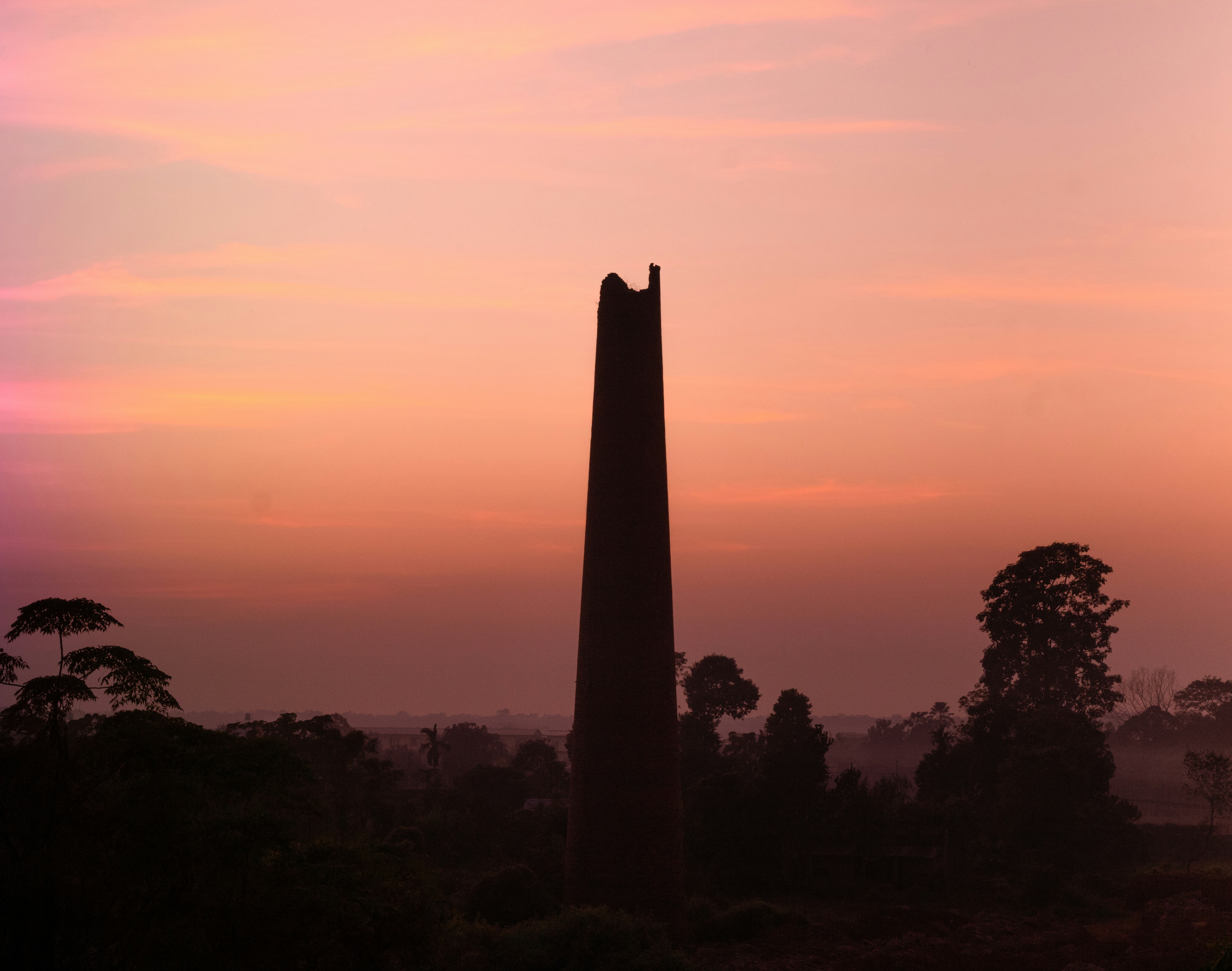 a very tall tower sitting in the middle of a field