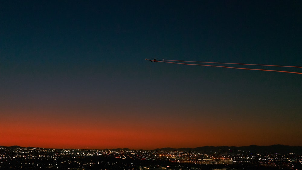 a plane flying over a city at night