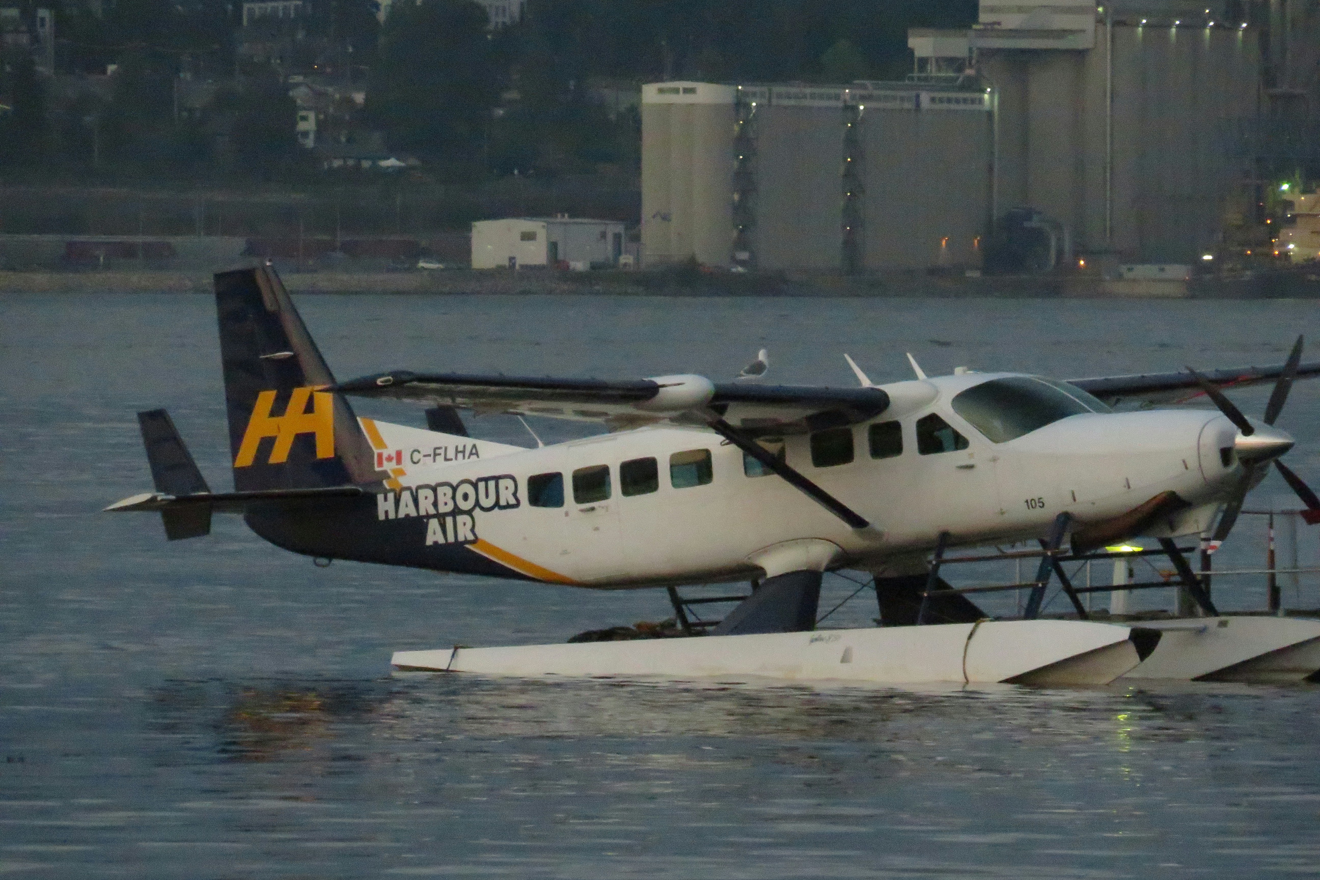 a small plane sitting on top of a body of water, 