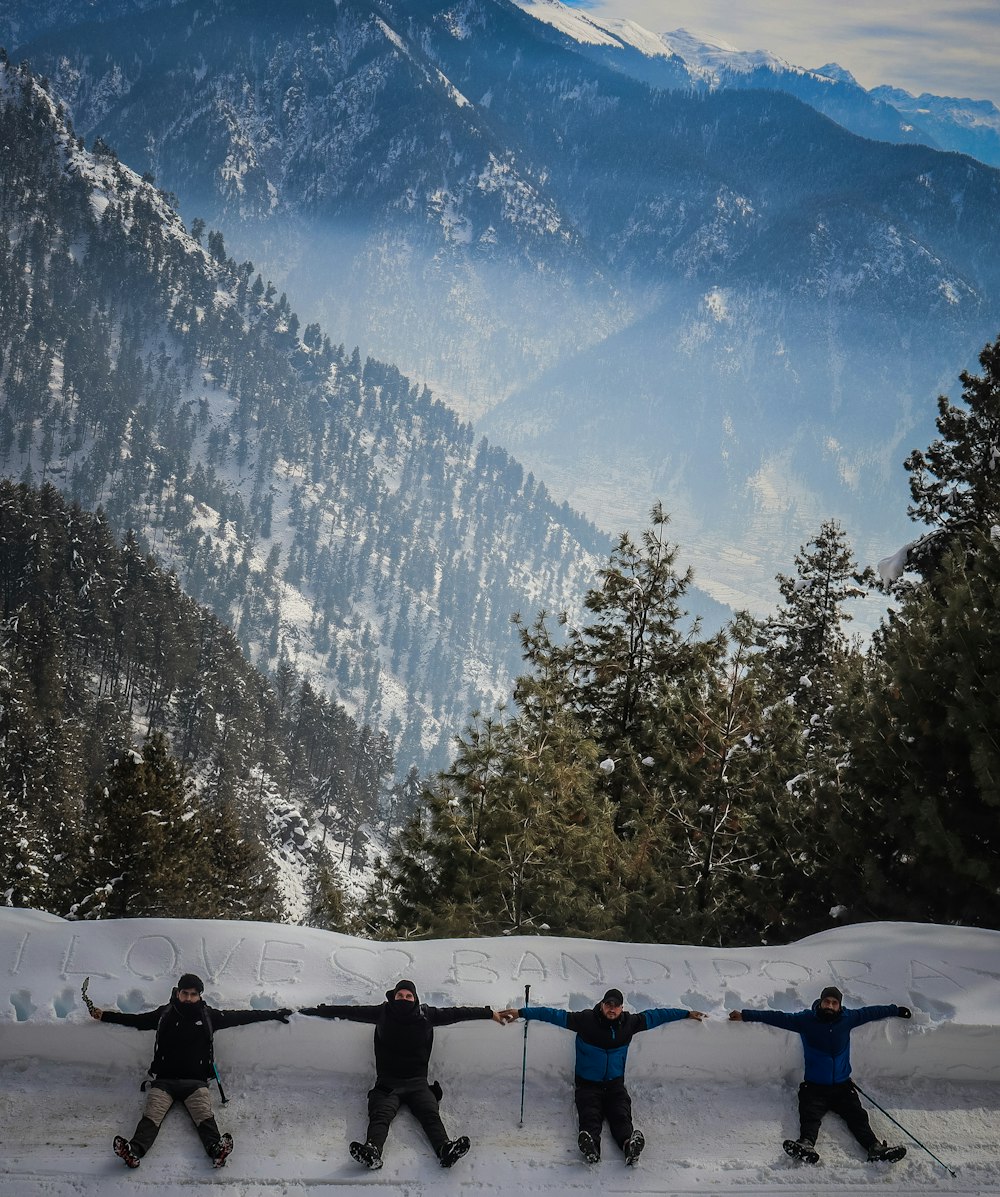 a group of people riding skis on top of a snow covered slope