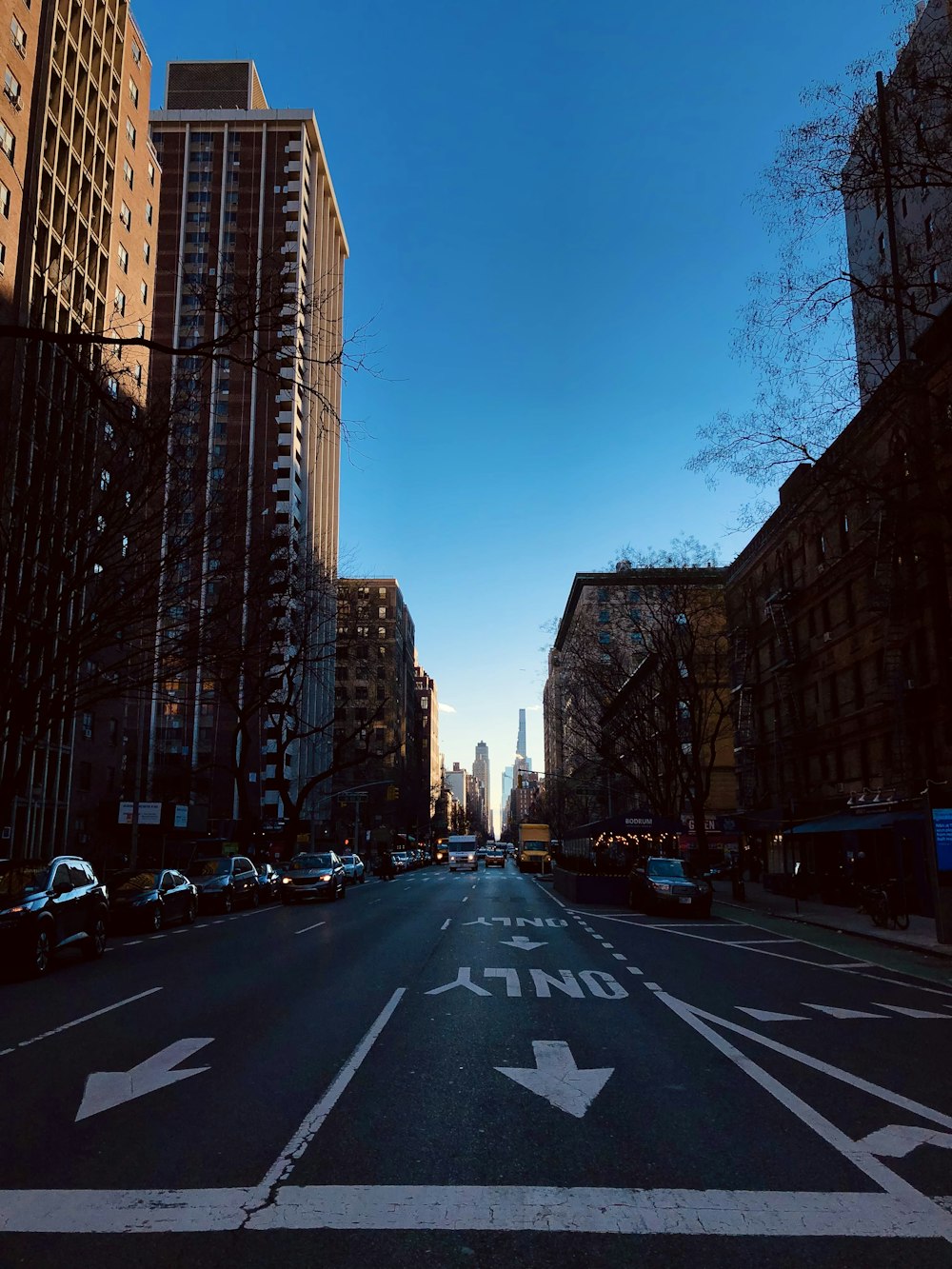 a city street with tall buildings on both sides