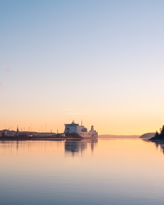 a large body of water with a building in the background