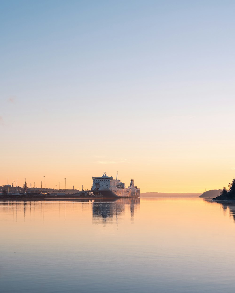 a large body of water with a building in the background