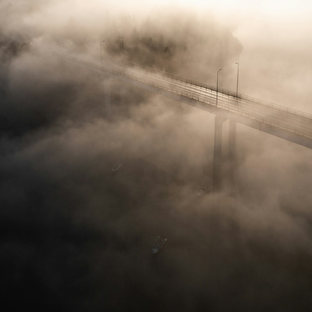 an aerial view of a bridge in the fog