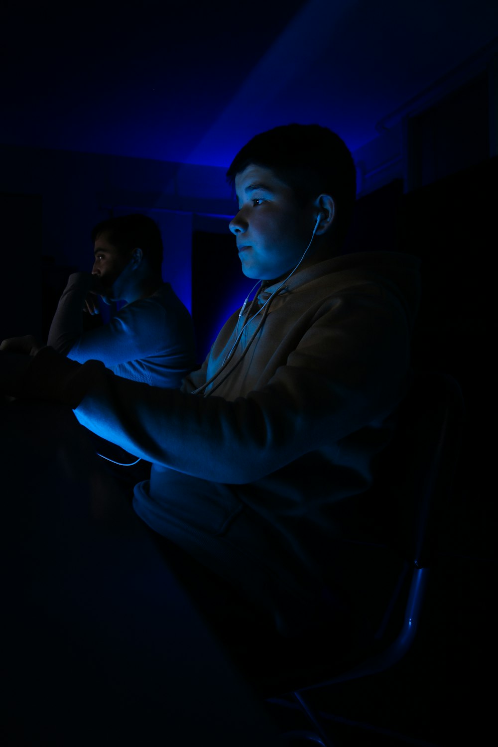 a man sitting at a table in a dark room