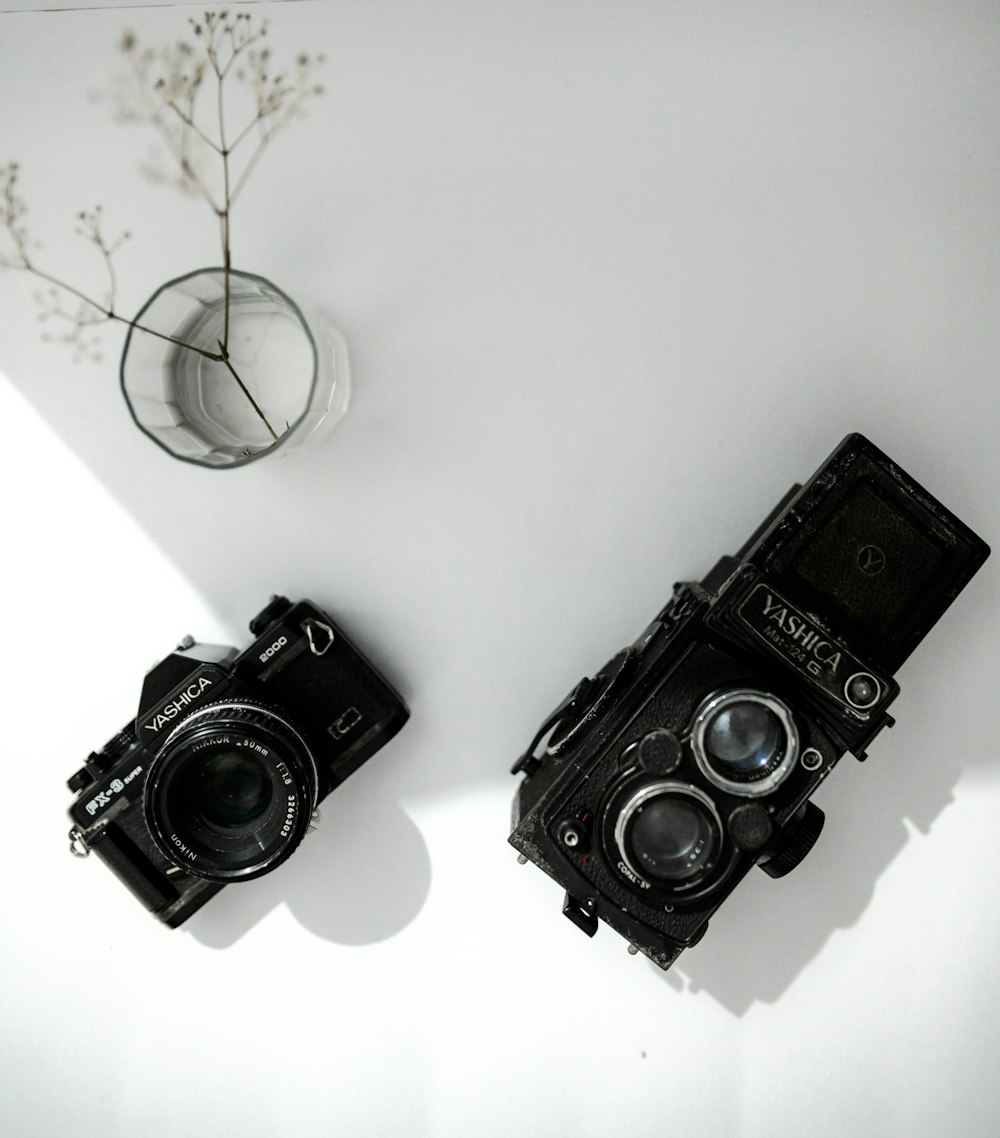 a couple of cameras sitting on top of a table